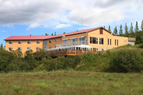 a large house on top of a hill at Hotel Hallormsstadur in Hallormsstaður