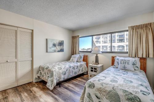 sypialnia z 2 łóżkami i oknem w obiekcie Carolina Dunes - 401 w mieście Myrtle Beach