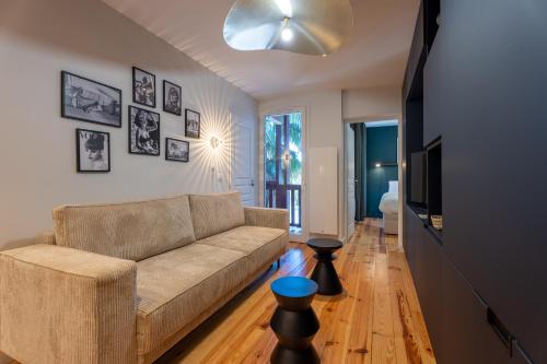 un salon avec un canapé et une télévision dans l'établissement Le Rosny - Séjour de prestige entre lac et golf, à Soorts-Hossegor