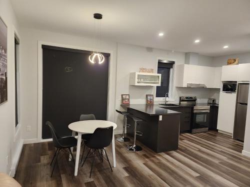 a kitchen with a table and chairs in a room at Appartement à sainte foy ( Quebec) in Quebec City