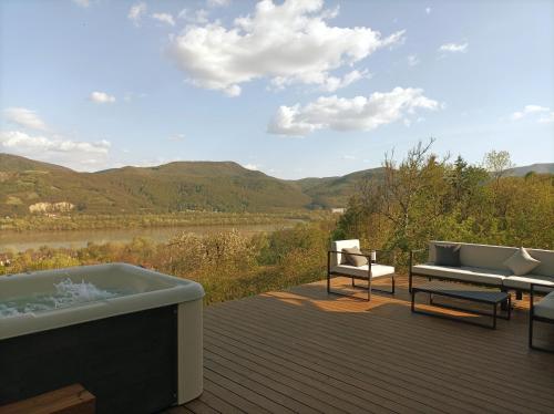 a bath tub sitting on top of a wooden deck at Hillside Nagymaros in Nagymaros