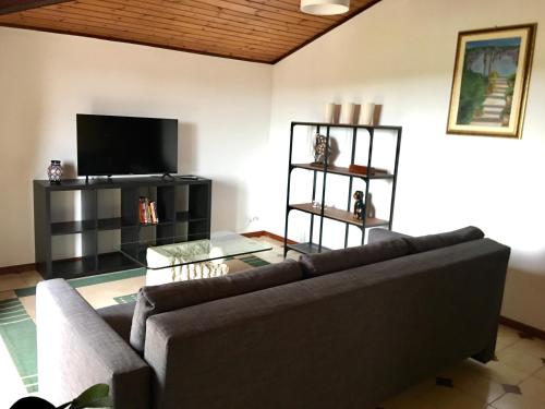 a living room with a couch and a flat screen tv at ETNA VIEW in Valverde