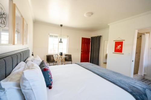a bedroom with a large white bed and a table at Viking Inn in Solvang