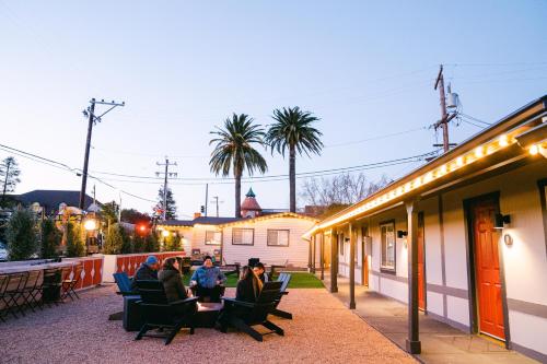 a group of people sitting in chairs on a patio at Viking Inn in Solvang
