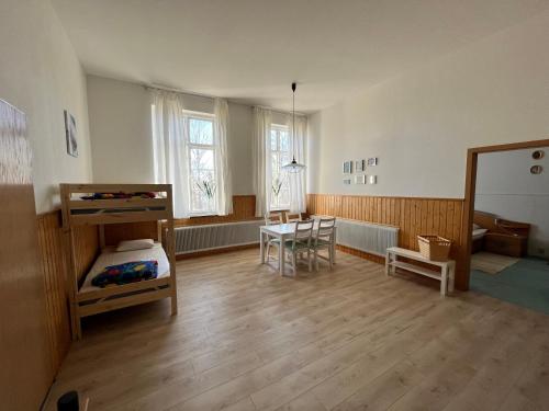 a room with a bedroom with a table and a bed at Vakantievilla Rämmen Skola in Rämmen