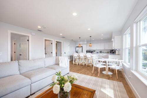 a living room with a white couch and a table at Bright and airy beach vacation spot- perfect for families and ocean views in Moss Beach
