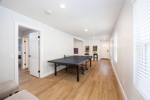 a dining room with a ping pong table in it at Bright and airy beach vacation spot- perfect for families and ocean views in Moss Beach