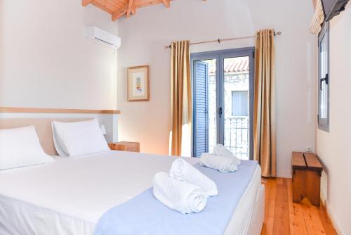 a bedroom with two white towels on a bed at Ryalos Villas in Kalamata