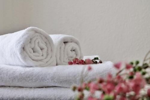 a pile of towels with flowers on top of them at A Estribor - 20001 in Argoños