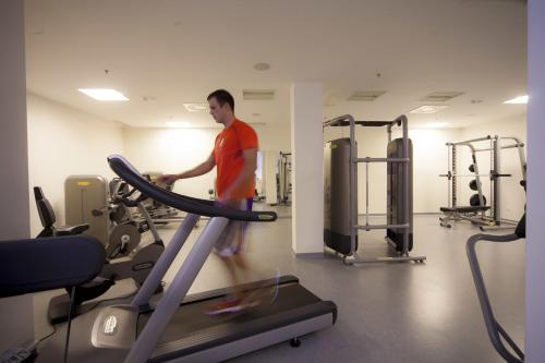 a man on a treadmill in a gym at Apartments Punta in Veli Lošinj