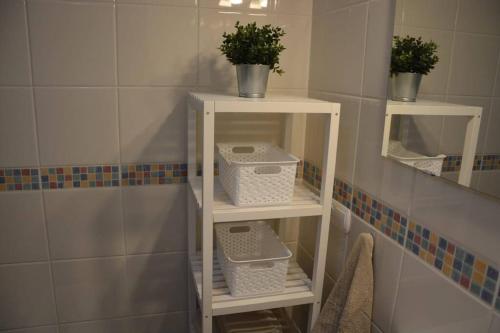 two white shelves with plants on them in a bathroom at Sonne Wind und Ocean La Tejita in La Tejita