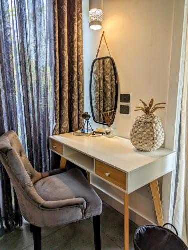 a desk with a mirror and a chair at La Rochér Eco Retreat in Stokers Siding