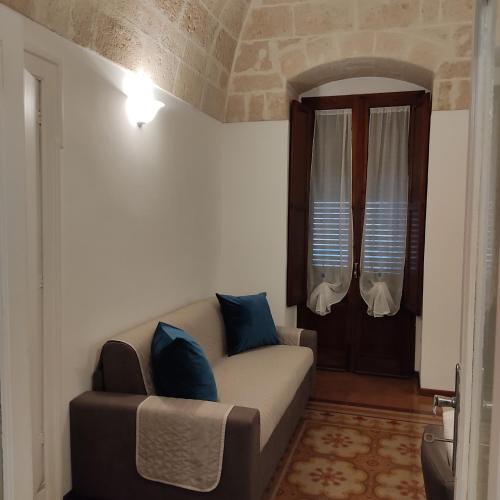 a living room with a couch and a window at DIMORA STORICA ALLA ROTONDA in Mottola