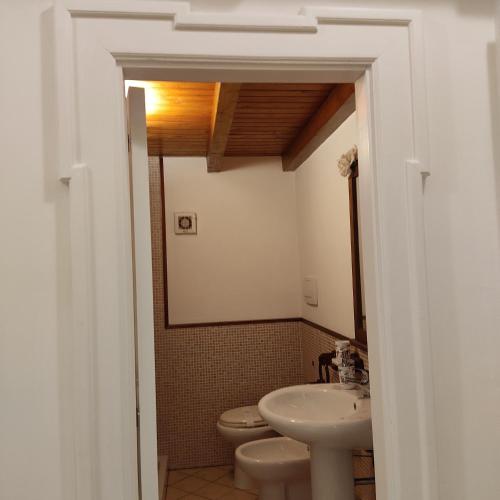 a bathroom with a sink and a toilet at DIMORA STORICA ALLA ROTONDA in Mottola