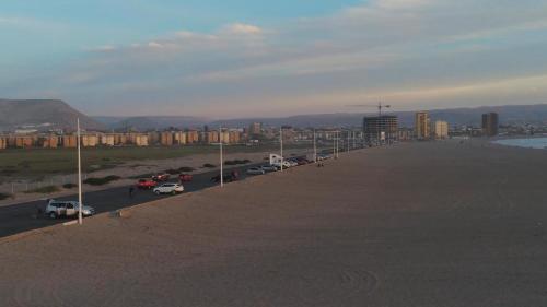 a road with cars parked in a parking lot at Villa frontera home in Arica