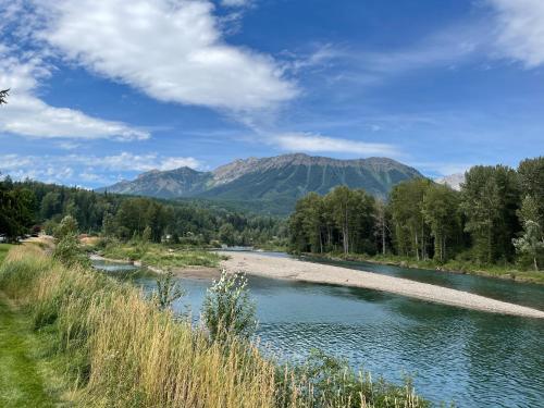 a river with a mountain in the background at Pinnacle Ridge Condos by Fernie Central Reservations in Fernie