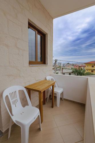 a table and chairs on a balcony with a view at Villa Abedini in Ksamil