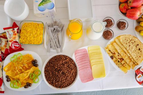 a table filled with different types of breakfast foods at Villa Abedini in Ksamil