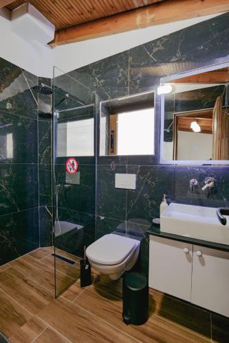 a bathroom with a toilet and a sink at Villa Abedini in Ksamil
