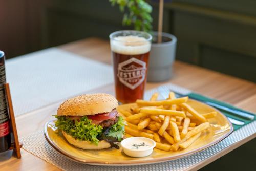 a plate with a sandwich and french fries and a drink at ibis Concepcion in Concepción