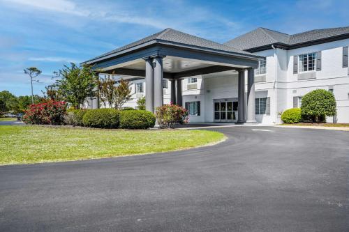 a large white building with a large gazebo at Blue Water Inn & Suites BW Signature Collection in North Topsail Beach