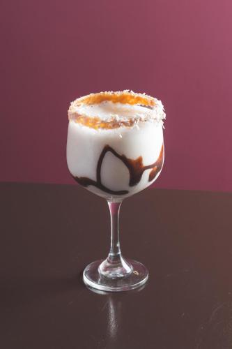 a drink in a glass with whipped cream and chocolate at Hotel Tungurahua in Baños