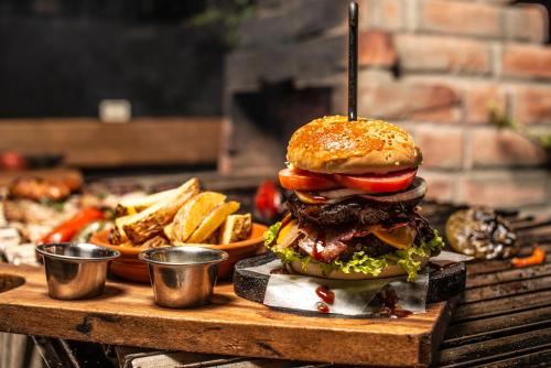 a hamburger and french fries on a table at Hotel Tungurahua in Baños