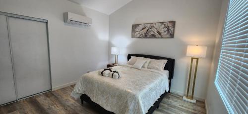 a bedroom with a bed with two shoes on it at Luxury family-friendly 2BR Home near downtown SD in National City