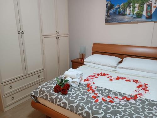 a bed with a heart made out of flowers on it at Sognando Alberobello in Alberobello
