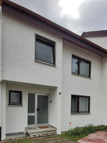 a white house with black windows at Stilvolles Haus 124 qm in Balingen