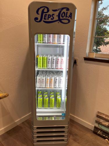 a refrigerator is full of drinks in a room at Horseshoe Bend Motel in Lovell