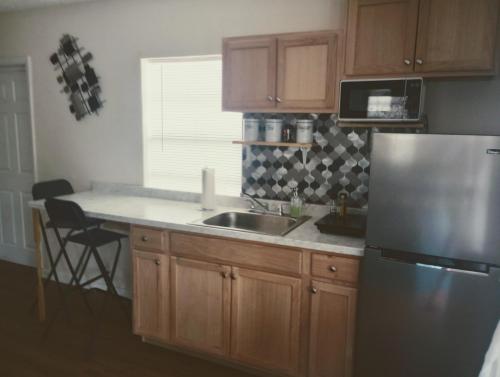 a kitchen with a sink and a refrigerator at cozy nice room in St. Petersburg