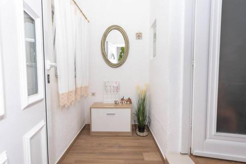a bathroom with a sink and a mirror on the wall at Peaceful house in nature nearby National Park Krka in Brištane