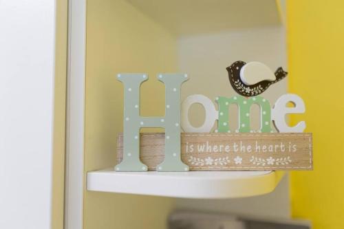 a sign that says home is where the heart is at Peaceful house in nature nearby National Park Krka in Brištane