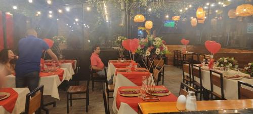 a group of people sitting at tables in a restaurant at Hotel Tungurahua in Baños