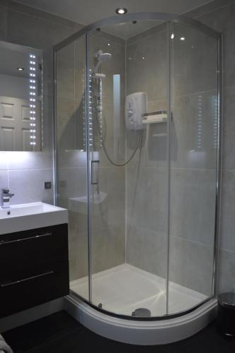 a shower with a glass enclosure in a bathroom at Library House in Liverpool