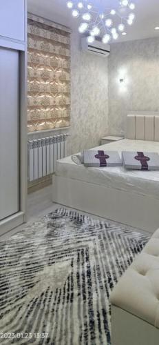 a bedroom with a large bed and a rug at Luxury Apartment in the Center 6 in Tashkent