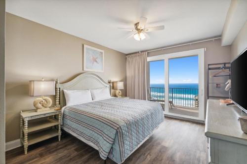 a bedroom with a bed and a view of the ocean at Sea-Renity at Laketown Wharf #1607 by Nautical Properties in Panama City Beach