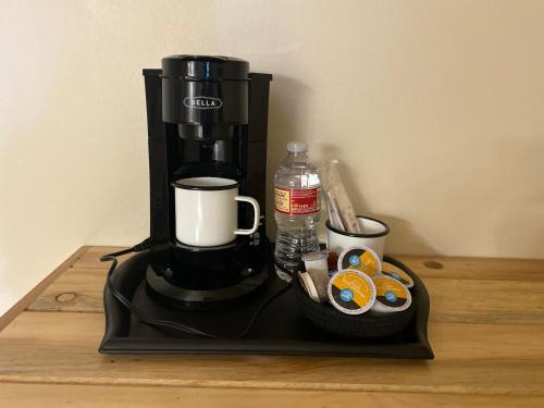 a coffee maker sitting on a black tray on a table at Horseshoe Bend Motel in Lovell