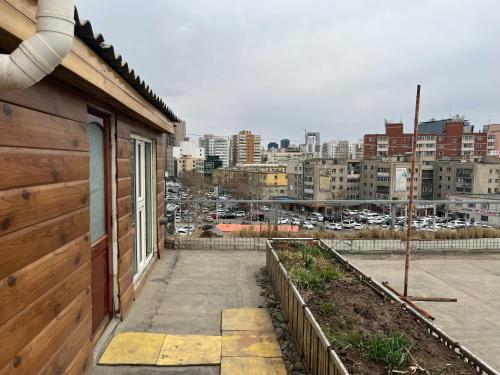 a balcony of a house with a view of a city at Gana's Guest House and Tours in Ulaanbaatar