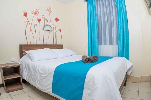a bedroom with a bed with towels on it at Hotel Tungurahua in Baños