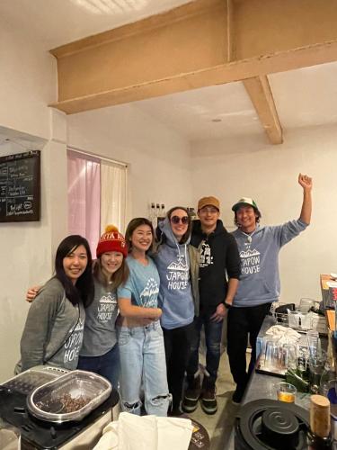 a group of people posing for a picture in a kitchen at Japow House 2 on Main Street in Myoko