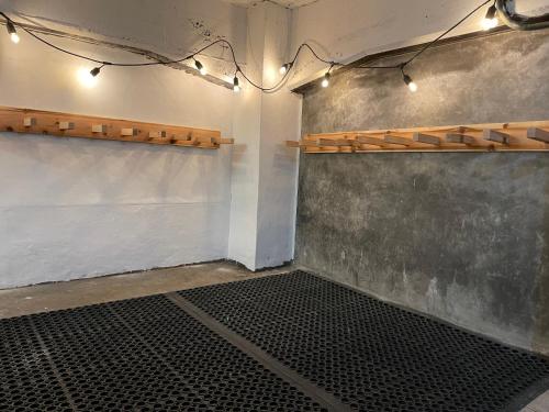 a room with a wall with a shelf and lights at Japow House 2 on Main Street in Myoko