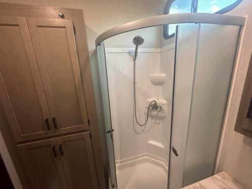 a shower in a bathroom with a glass door at Temecula Hilltop View Glamping Next To Wineries in Temecula