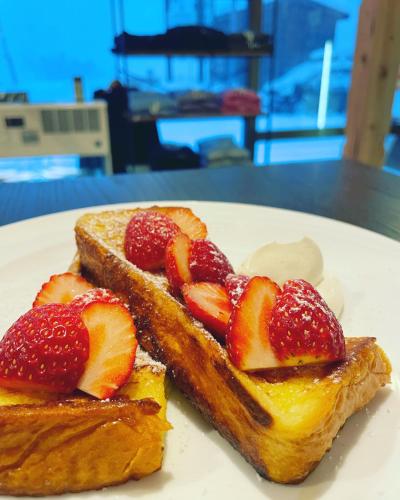 two pieces of toast with strawberries on a white plate at Japow House 2 on Main Street in Myoko