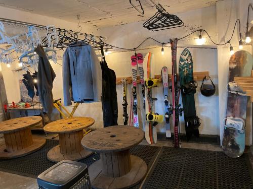 a store with tables and skis in a room at Japow House 2 on Main Street in Myoko