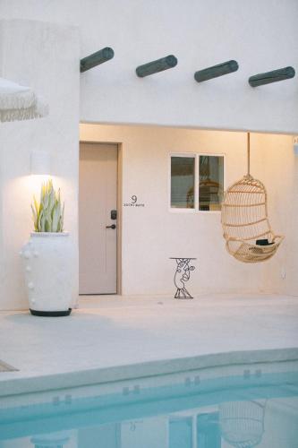 a house with a swimming pool and a bird cage at Yara Hotel - Adults Only in Palm Springs