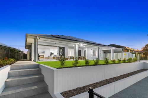 a rendering of a house with a white fence at Osprey Oasis in Banksia Beach