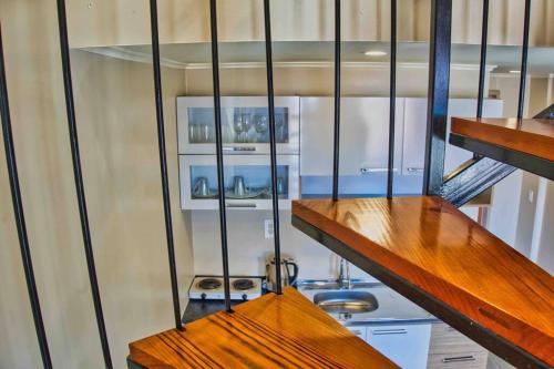 a room with some wooden shelves and some stairs at City Views Spacious Mezzanine Apartments in Willemstad