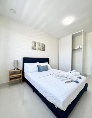 a white bedroom with a large bed and a table at Modern Townhouse with terrace! in Homestead